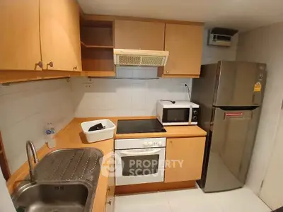 Cozy kitchen with wooden cabinets, modern appliances, and ample counter space.