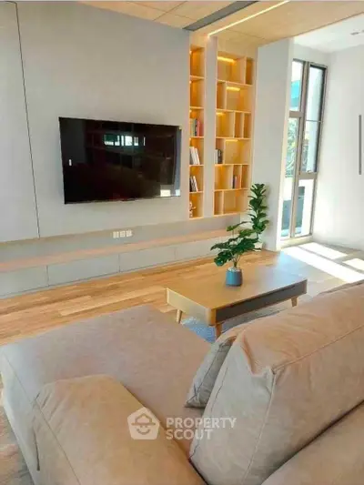 Modern living room with sleek TV setup and natural light
