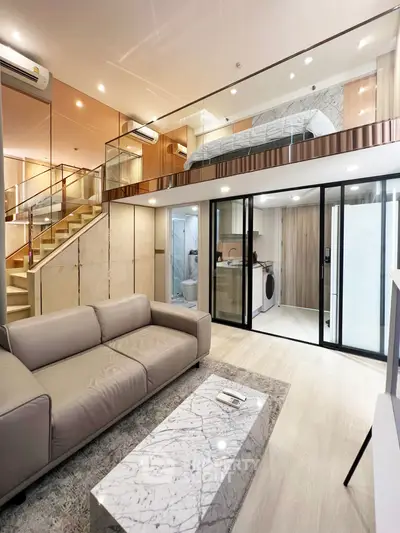Modern loft apartment with stylish living room and mezzanine bedroom, featuring sleek design and ample natural light.