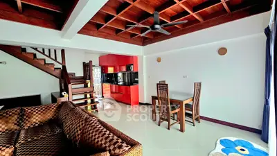 Stylish living room with wooden ceiling and modern kitchen in open layout