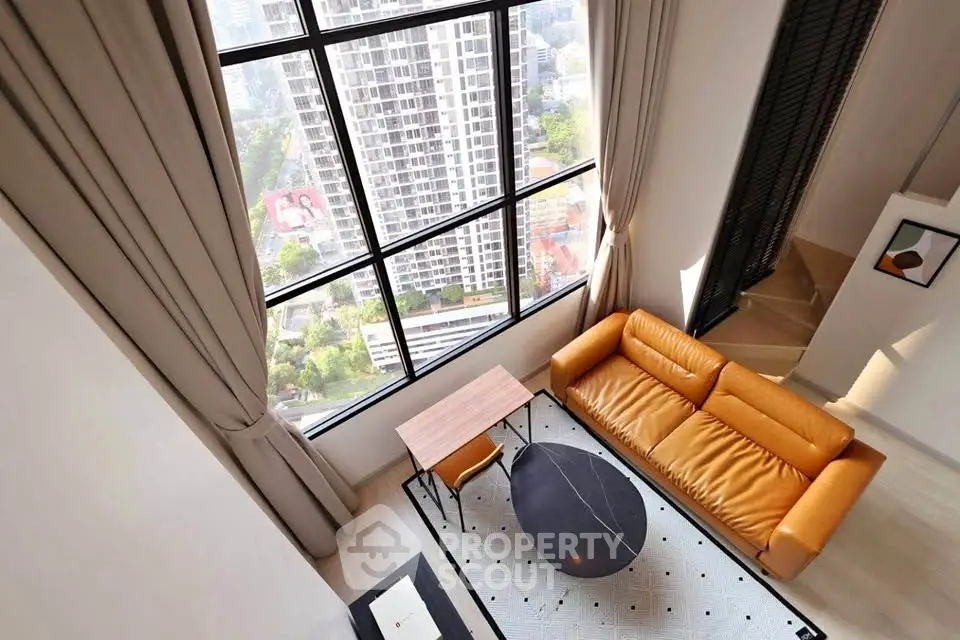 Stunning high-rise living room with floor-to-ceiling windows and city view
