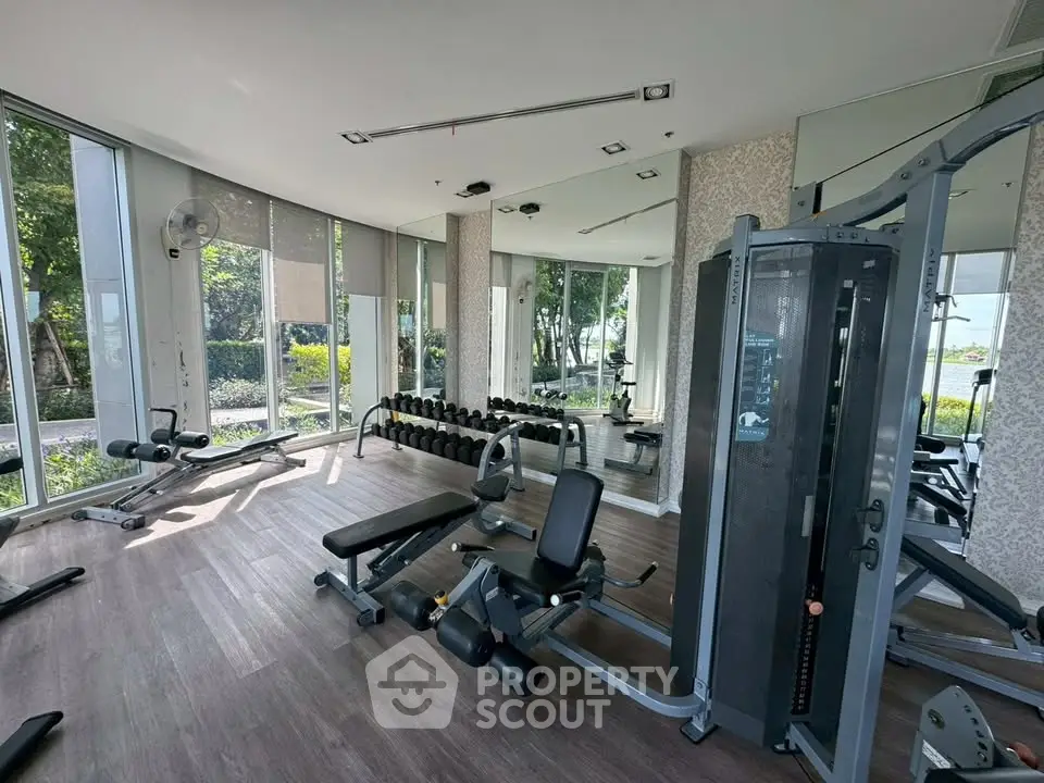 Modern gym with state-of-the-art equipment and large windows offering scenic views.