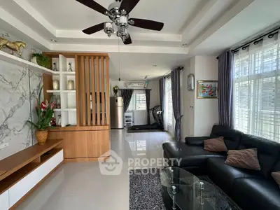 Spacious living room with modern decor and large windows for natural light.