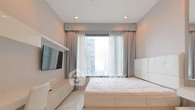 Modern bedroom with large window and city view, featuring sleek furniture and neutral tones.