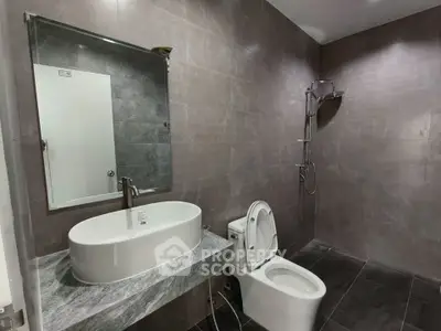 Modern bathroom with sleek fixtures and spacious shower area.