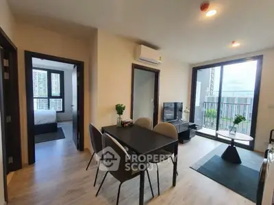 Modern apartment living room with dining area and balcony view