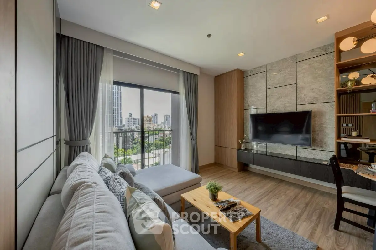 Modern living room with city view, stylish decor, and cozy seating area.