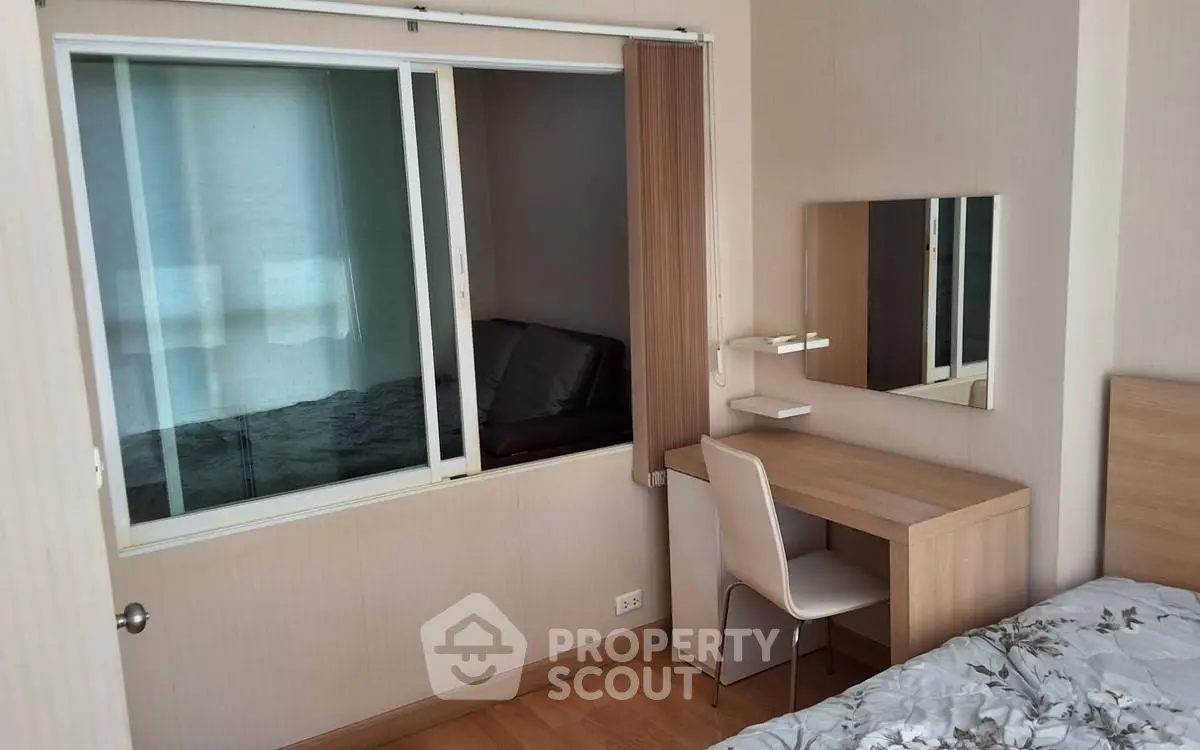 Cozy bedroom with study nook and modern decor in a stylish apartment.