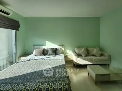Spacious bedroom with modern decor and natural light