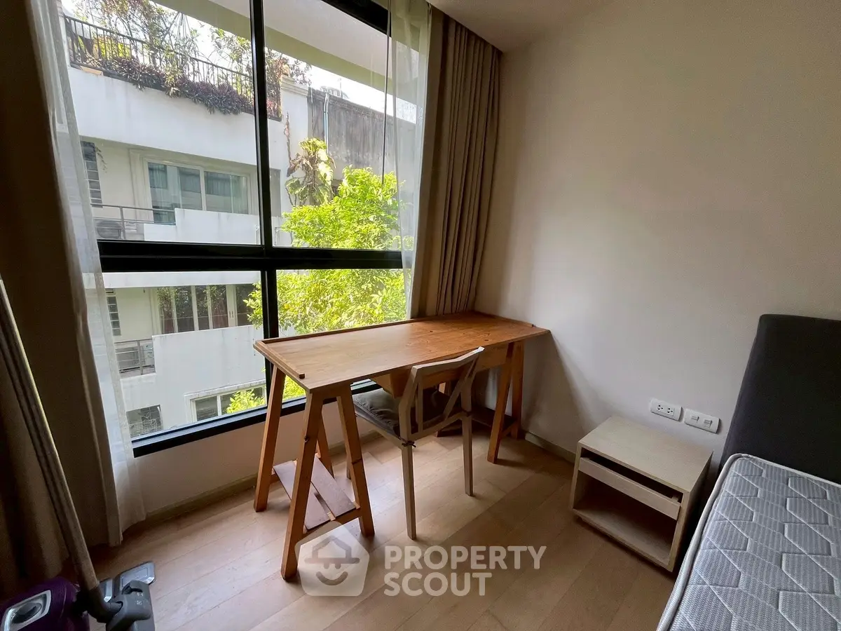 Cozy study nook with natural light and garden view in modern apartment
