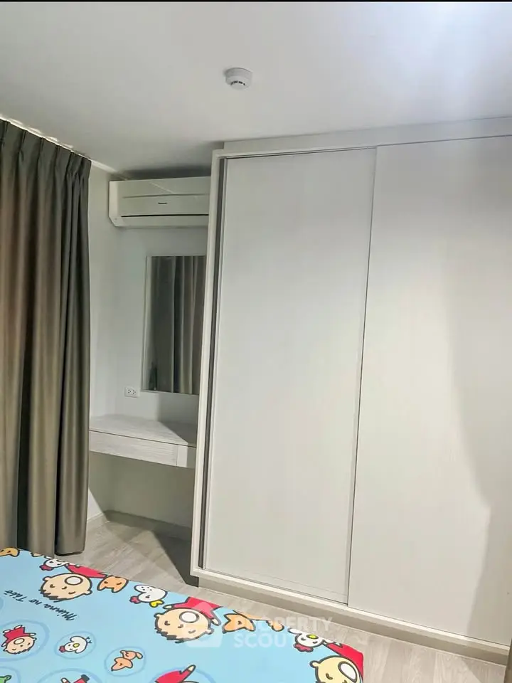 Cozy bedroom with built-in wardrobe and air conditioning, perfect for comfortable living.