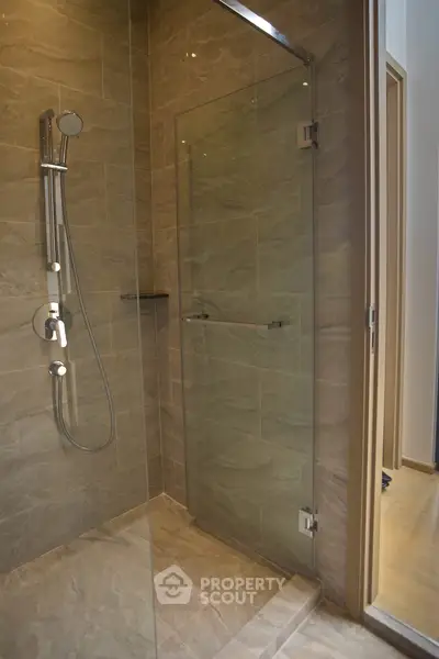 Modern bathroom with glass shower enclosure and sleek fixtures
