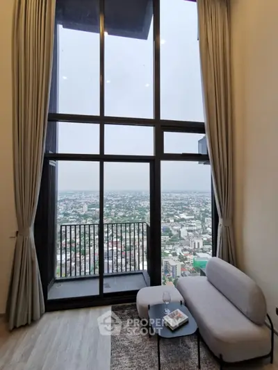 Stunning high-rise living room with floor-to-ceiling windows and breathtaking city view.