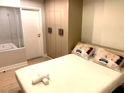 Cozy bedroom with modern wardrobe and ensuite bathroom view