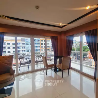 Spacious living room with large windows and balcony view in modern apartment