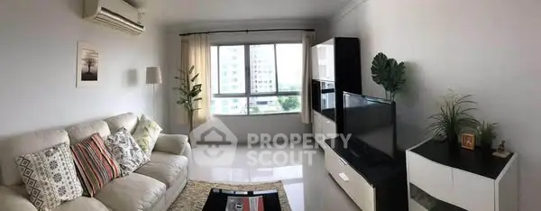 Spacious living room with modern decor and large window view