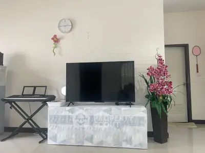 Modern living room with TV, keyboard, and elegant decor