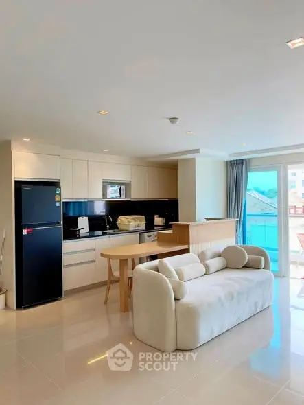 Modern open-plan kitchen with sleek appliances and cozy living area