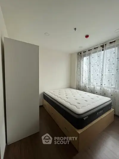 Cozy bedroom with natural light and modern furnishings