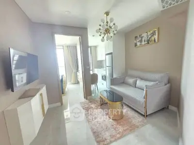 Modern living room with stylish decor and open kitchen layout in a contemporary apartment.