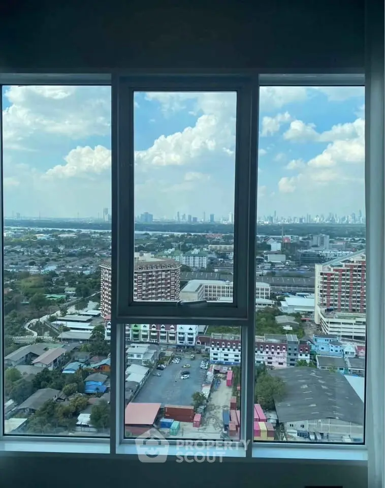 Stunning cityscape view from high-rise apartment window, showcasing urban skyline and expansive horizon.