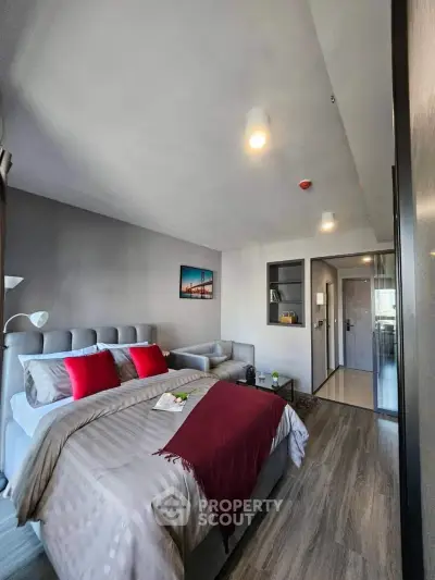 Modern bedroom with stylish decor and cozy ambiance, featuring a plush bed and elegant lighting.