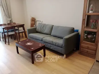 Cozy living room with elegant wooden furniture and a comfortable sofa, perfect for relaxation and gatherings.