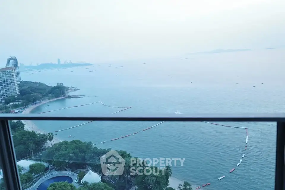 Stunning ocean view from high-rise balcony overlooking serene coastline.