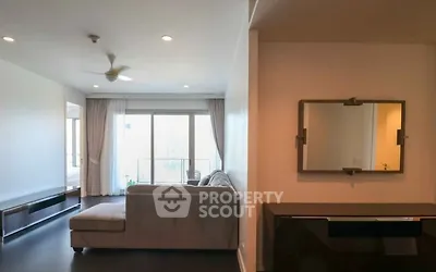 Spacious living room with modern decor and large windows for natural light.