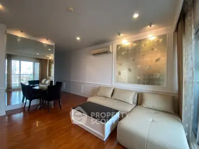 Spacious living room with modern decor and large windows offering natural light.