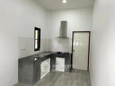 Modern minimalist kitchen with sleek countertops and gas stove