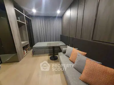 Modern bedroom with cozy sofa and stylish decor in a contemporary apartment.