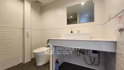 Modern bathroom with sleek fixtures and white tile design