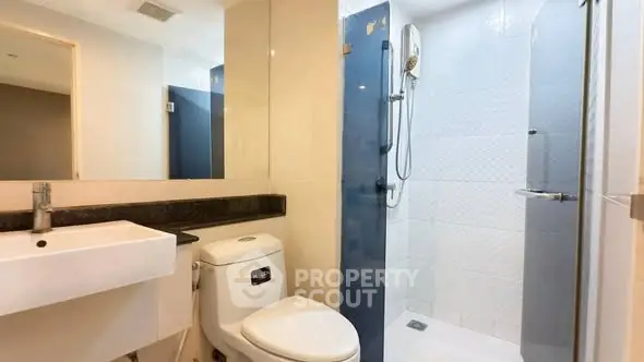 Modern bathroom with sleek fixtures and spacious shower area