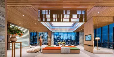Luxurious modern living room with city skyline view, elegant decor, and ambient lighting.