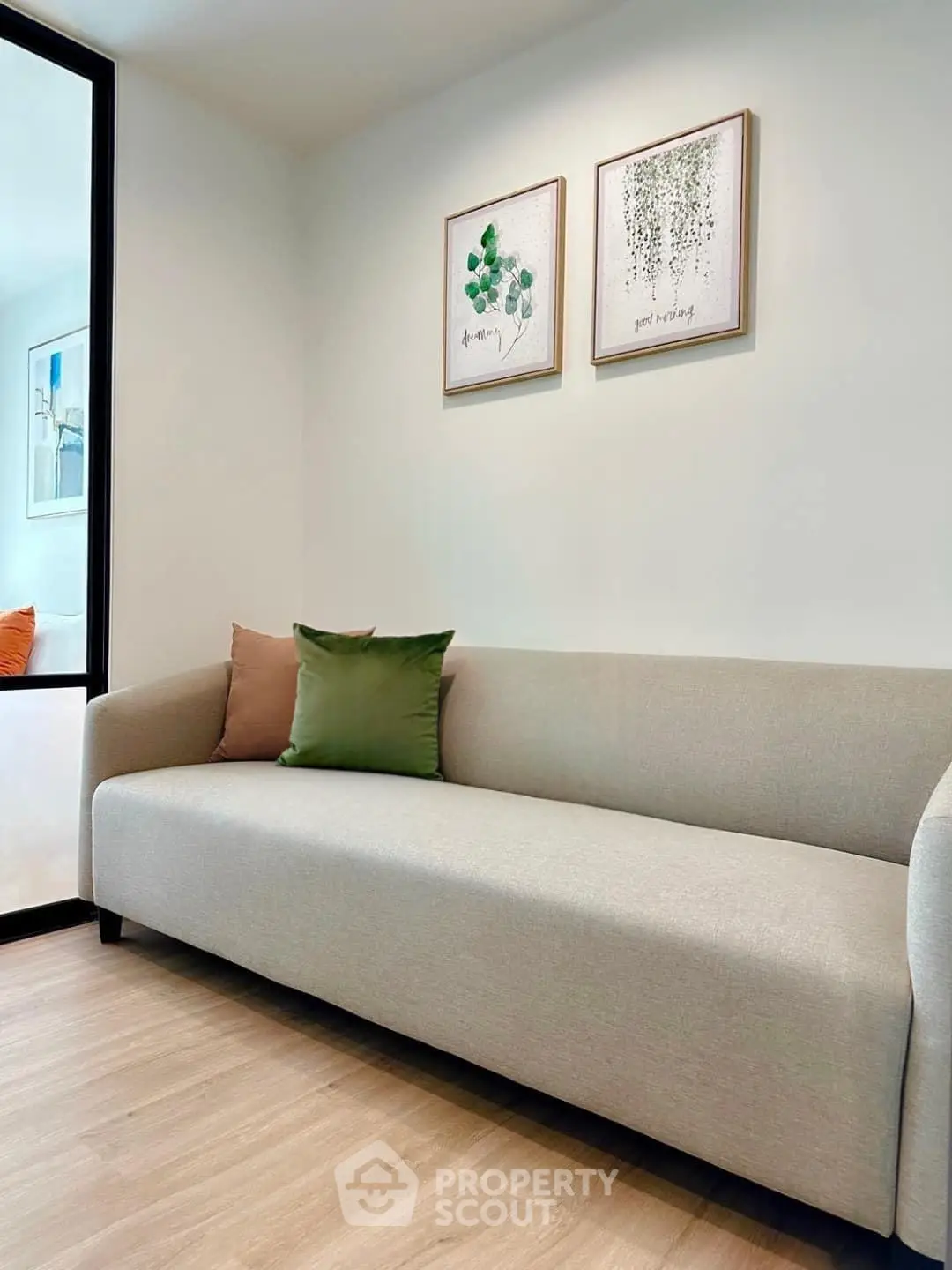 Modern living room with stylish sofa and decorative wall art in a cozy apartment.