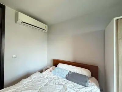 Cozy bedroom with air conditioning and modern decor, perfect for relaxation and comfort.