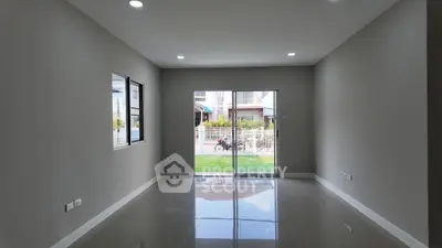 Spacious modern living room with large windows and sliding glass doors.
