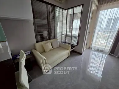 Modern living room with sleek design and large windows offering city views