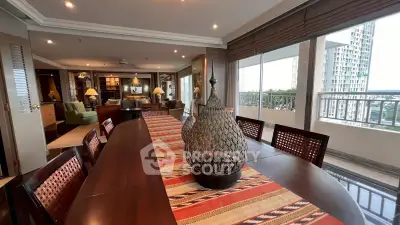 Spacious living and dining area with large windows and modern decor in a high-rise apartment.