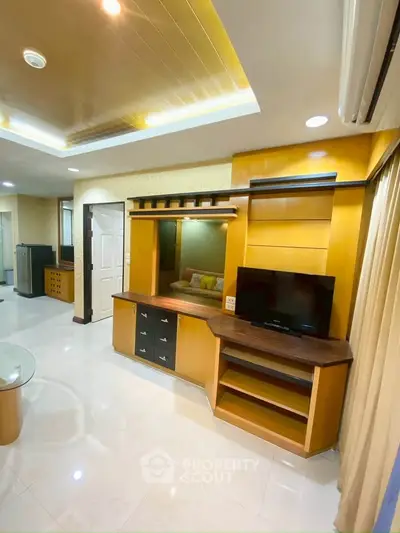 Modern living room with built-in wooden entertainment center and sleek design.
