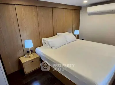 Cozy bedroom with modern wooden paneling and ambient lighting