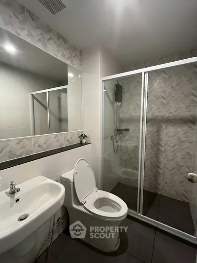 Modern bathroom with sleek shower enclosure and stylish tile design