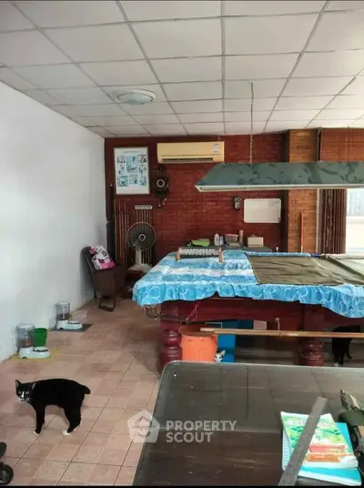 Spacious room with pool table and air conditioning, perfect for entertainment and relaxation.