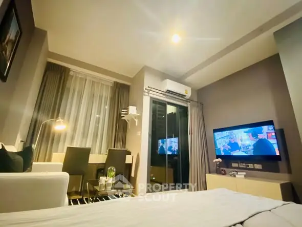 Modern living room with cozy seating and wall-mounted TV in stylish apartment