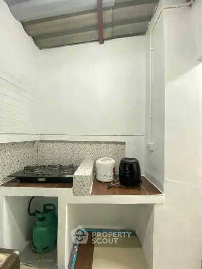 Compact kitchen with gas stove and modern appliances in a cozy home setting.