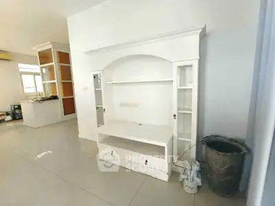 Spacious living room with elegant white entertainment unit and modern decor