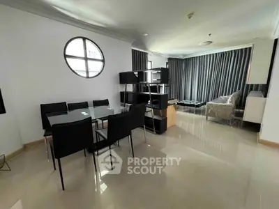 Spacious modern living room with dining area and stylish furniture in a bright apartment.