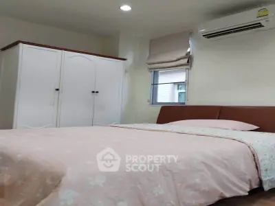 Cozy bedroom with air conditioning and wardrobe, perfect for relaxation.
