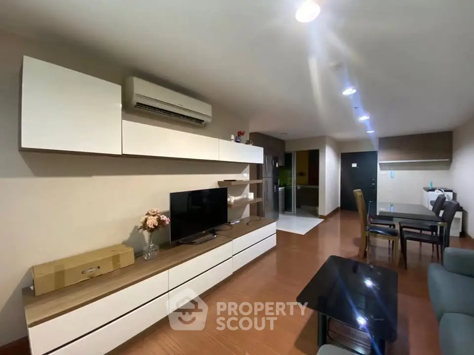 Modern living room with sleek furniture and open dining area, perfect for contemporary living.